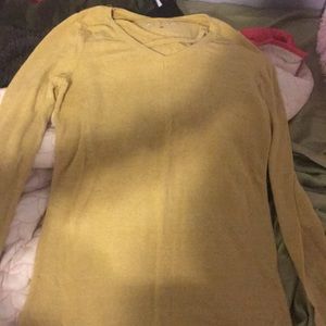 Yellow shirt, crosses in the front